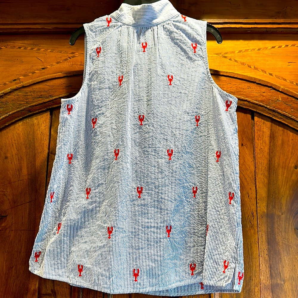 Sleeveless, high neck, tie back seersucker top with lobster details
